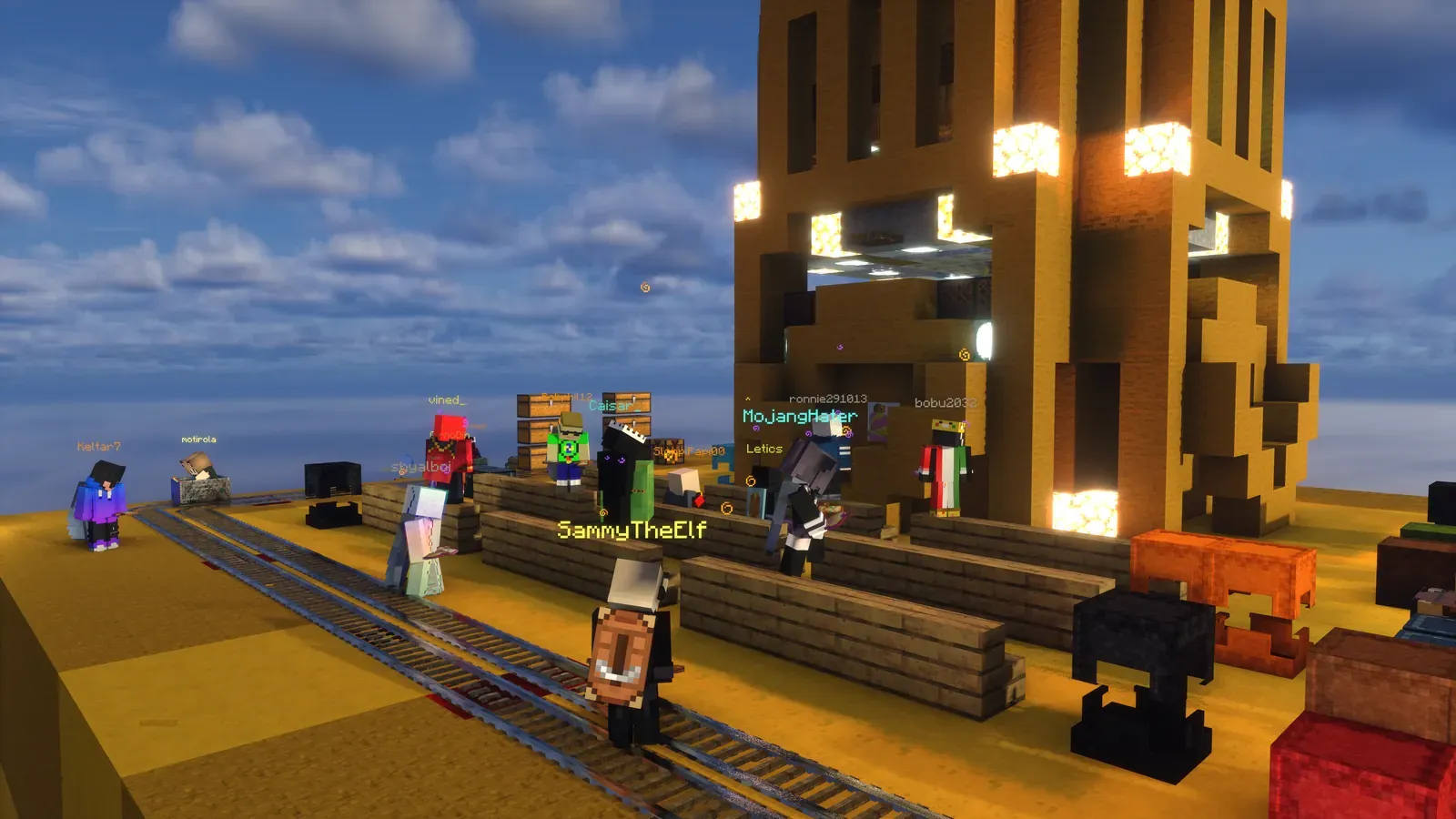 6b6t players with minecarts on rollercoaster tracks at the foot of the giant Kyr0Zen statue at Kyr0land on CosmoWorld night 1.