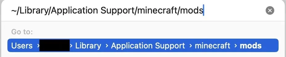 The Finder Go to Folder box on macOS with ~/Library/Application Support/minecraft/mods typed in and the mods folder found