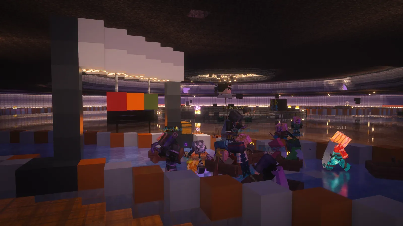 Players racing boats on a track of ice in a dark hall decorated in orange and white at the Halloween after party
